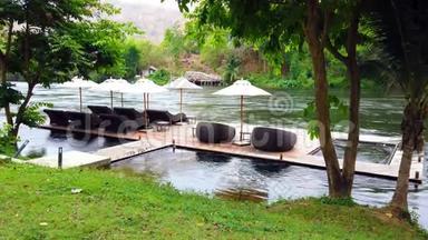 泰国葵坎查纳布里河附近<strong>度假</strong>胜地的海滨木筏上的躺椅或日光浴床和雨伞。 旅游和<strong>度假</strong>